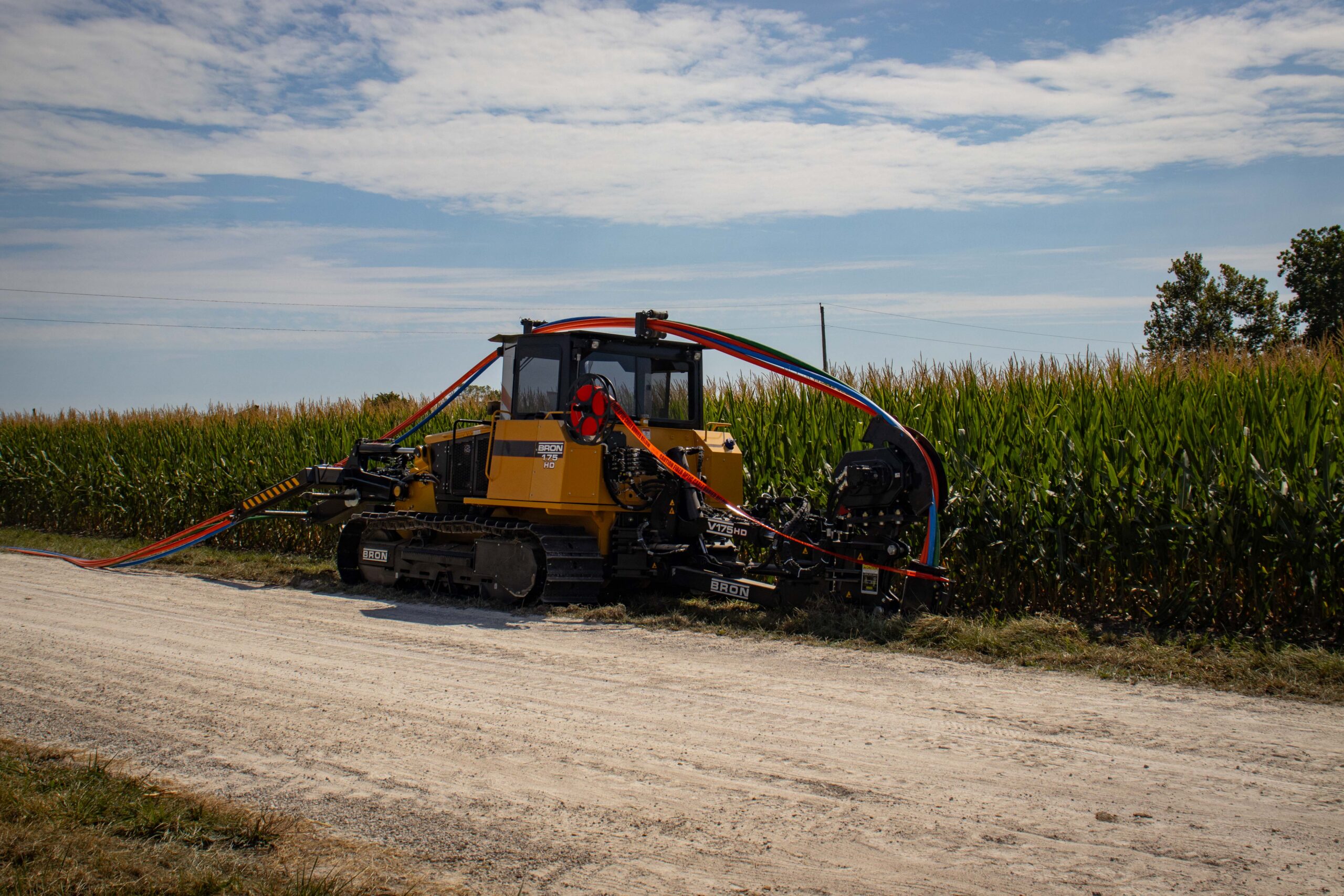 Bron 175 utility plow in front of corn field